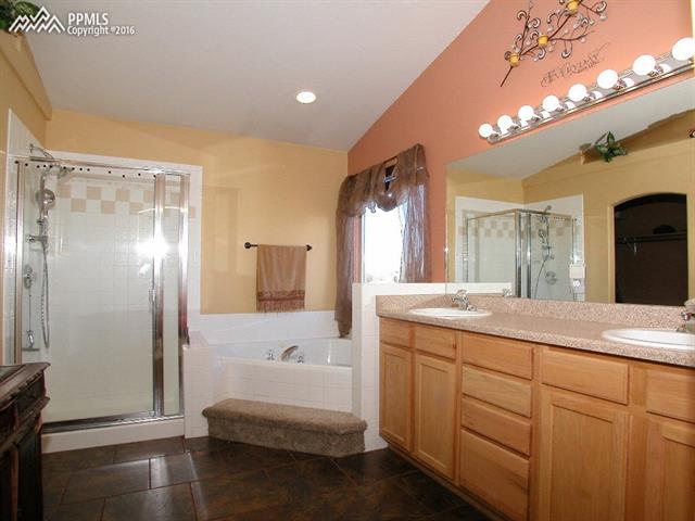 12153 Rio Secco Road Peyton, CO 80831 - Photo 12 of 26 5 pc master bath with jetted tub & heated tile floors