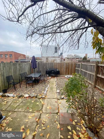 a view of a chairs and table in backyard