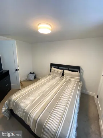 a bedroom with a bed and a night stand