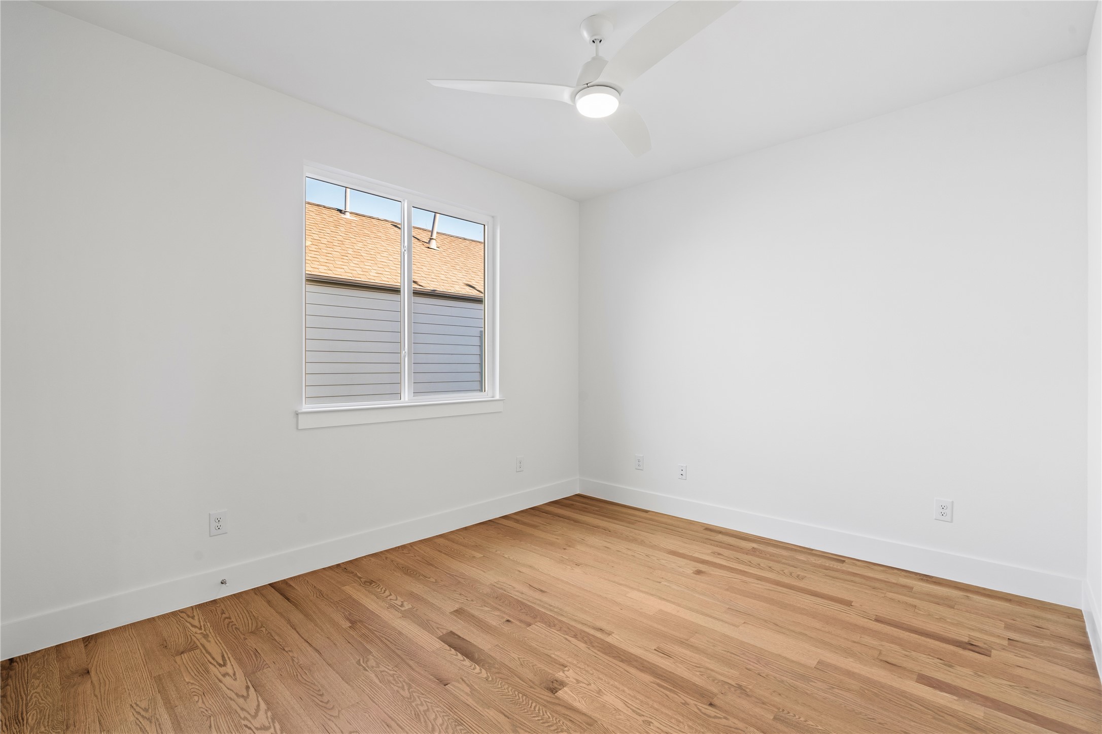 5404 Mulvey Street Houston, TX 77020 - Photo 24 of 28 an empty room with wooden floor and windows