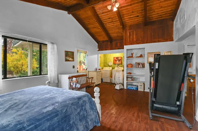 a bed room with a bed window and a chair