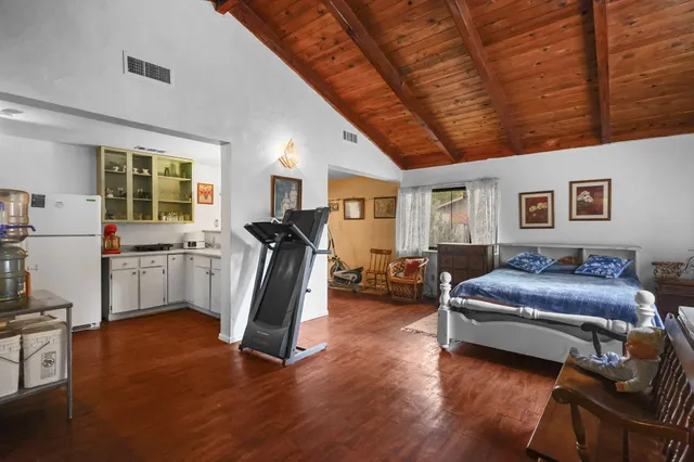 a living room with furniture gym equipment and a large window