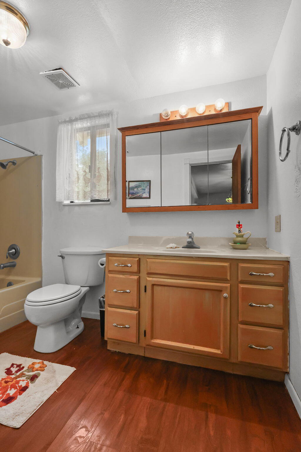 18385 Bowman Road Cottonwood, CA 96022 - Photo 15 of 39 a spacious bathroom with a granite countertop sink mirror and toilet