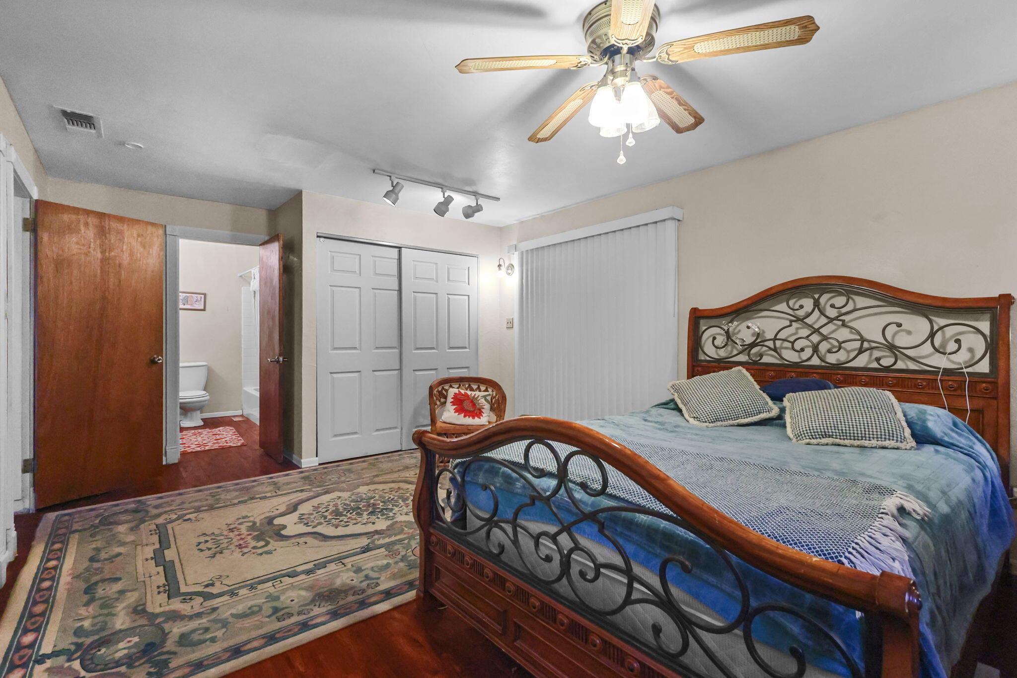 18385 Bowman Road Cottonwood, CA 96022 - Photo 16 of 39 a bedroom with furniture and a chandelier