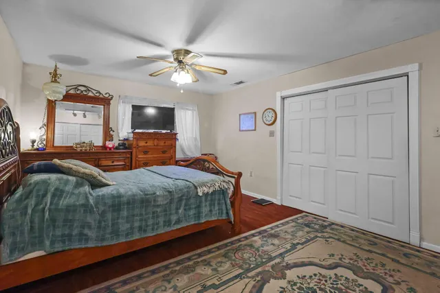 a bedroom with a large bed and a chandelier