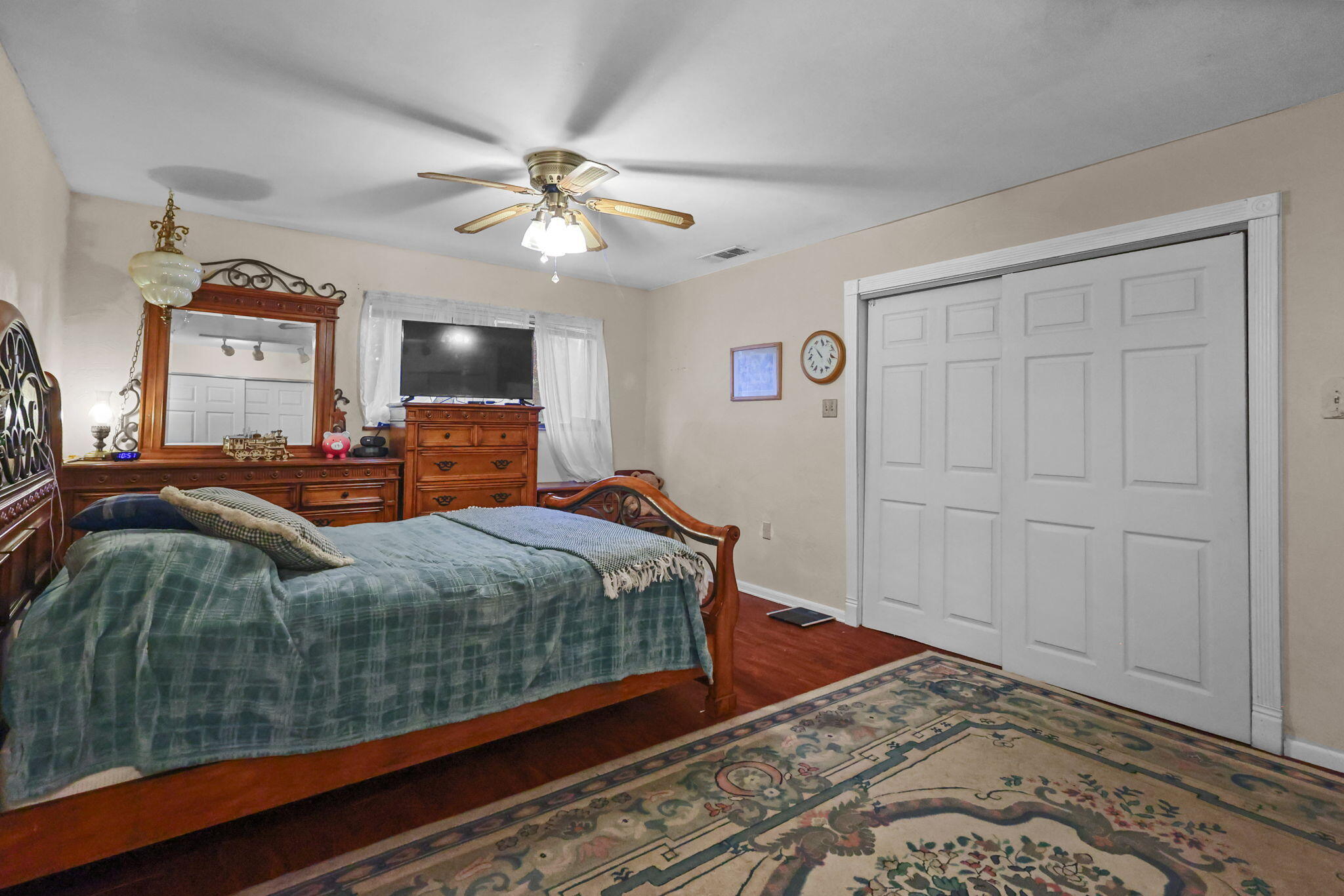 18385 Bowman Road Cottonwood, CA 96022 - Photo 18 of 39 a bedroom with a large bed and a chandelier