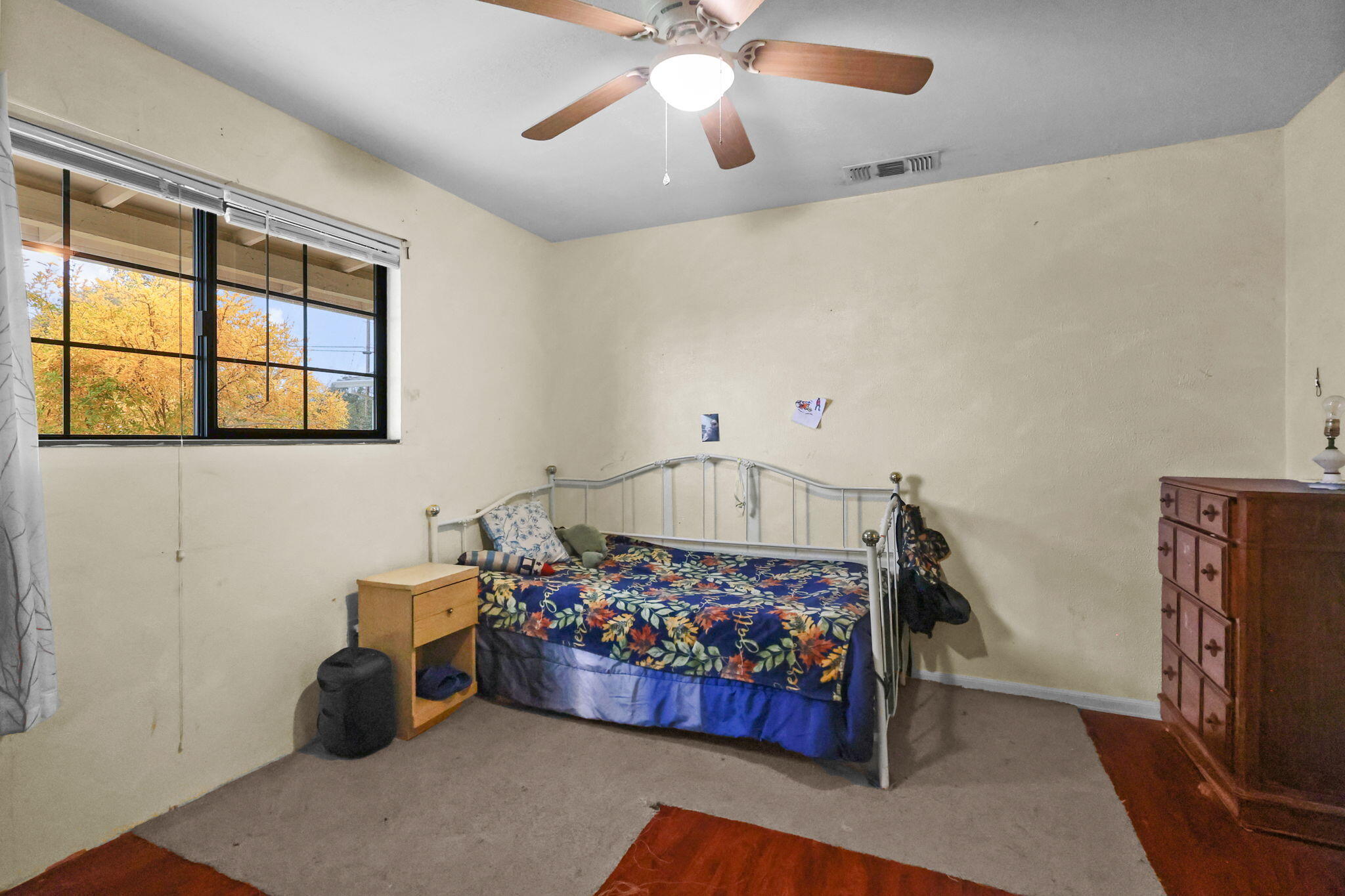 18385 Bowman Road Cottonwood, CA 96022 - Photo 21 of 39 a bedroom with furniture and a chandelier fan