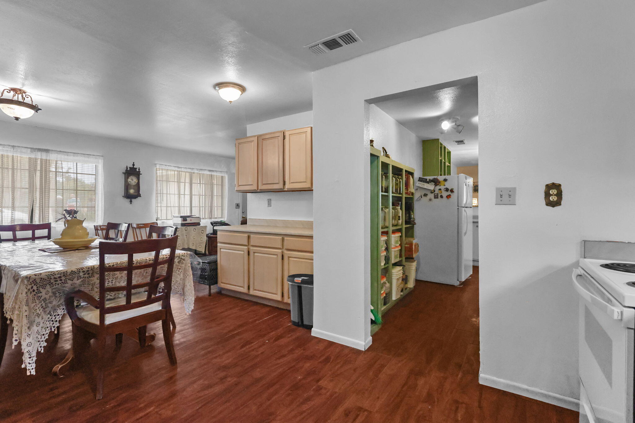 18385 Bowman Road Cottonwood, CA 96022 - Photo 5 of 39 a kitchen with a refrigerator a table and chairs