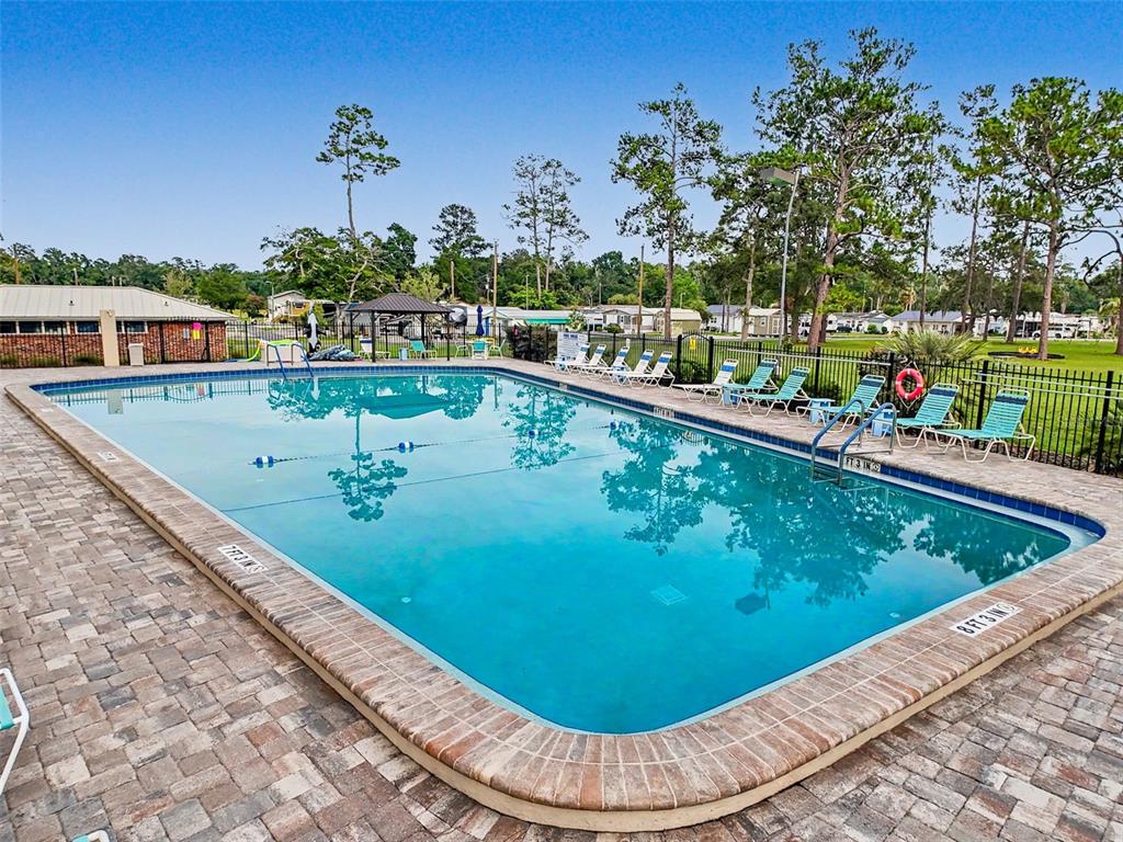 2092 Culbreath Road, Unit A42 Brooksville, FL 34602 - Photo 36 of 70 a view of a swimming pool with an outdoor seating