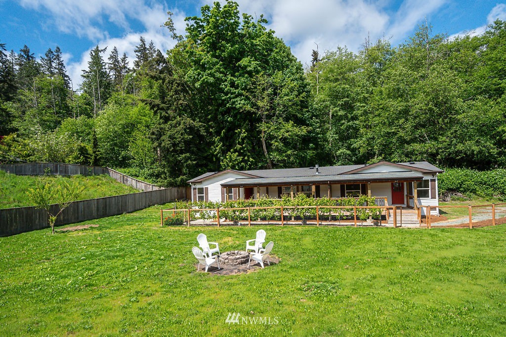 1815 Newman Road Freeland, WA 98249 - Photo 1 of 26 a view of a house with a swimming pool and sitting area