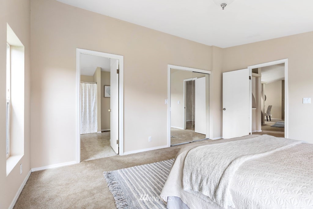 1815 Newman Road Freeland, WA 98249 - Photo 13 of 26 a bedroom with a bed and a mirror