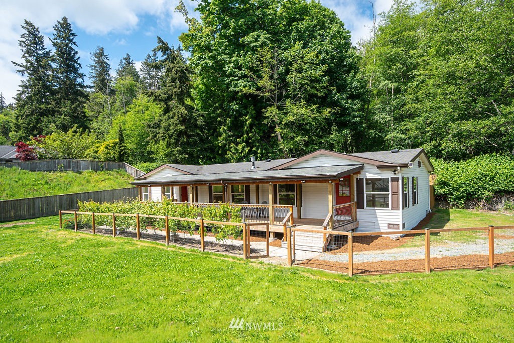 1815 Newman Road Freeland, WA 98249 - Photo 23 of 26 a view of a house with a backyard patio and a garden