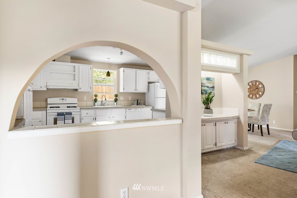 1815 Newman Road Freeland, WA 98249 - Photo 6 of 26 a large white kitchen with a large window