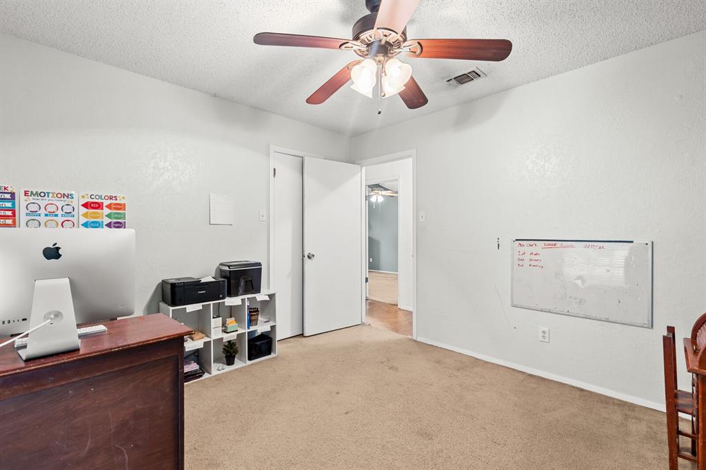 505 Pinewood Lane Hewitt, TX 76643 - Photo 22 of 38 Carpeted room featuring a ceiling fan with light fixture, white walls, and a doorway opening to an additional interior space