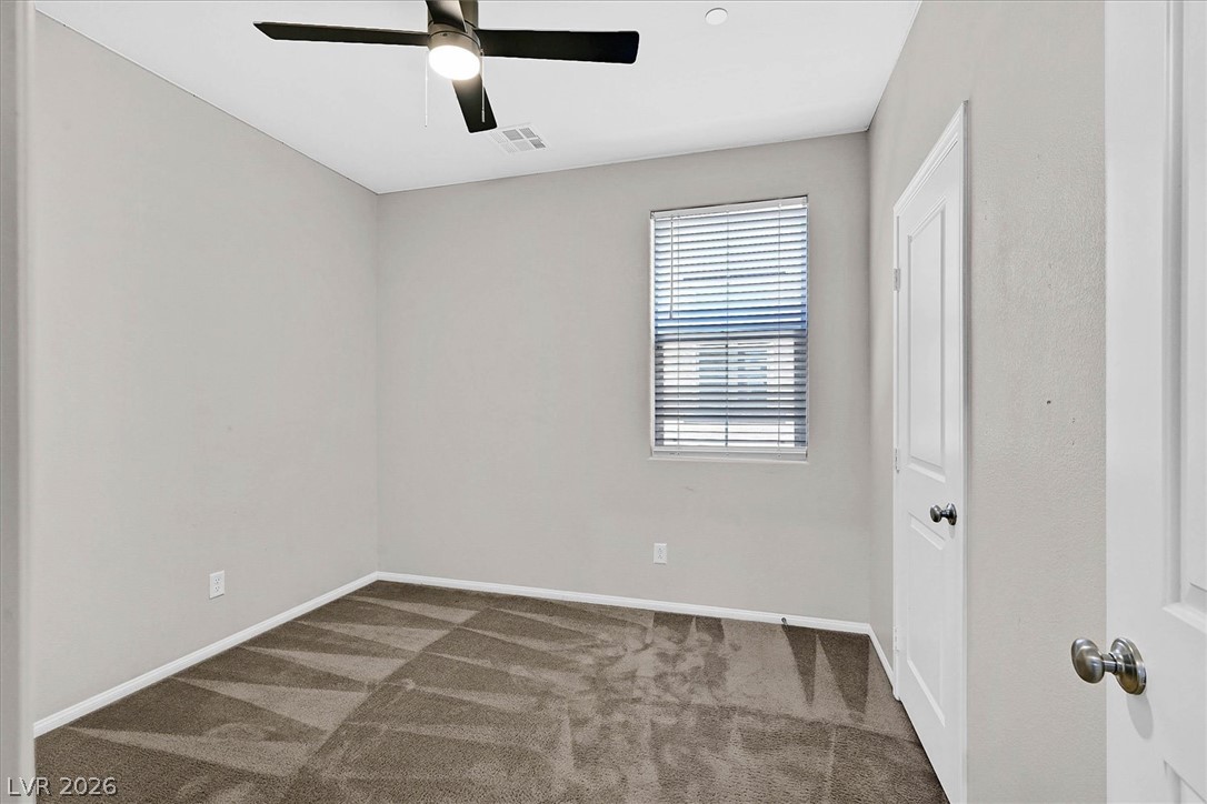 2823 Turnstone Ridge Street Henderson, NV 89044 - Photo 21 of 25 A well-proportioned room with carpeted flooring and ample overhead lighting for comfortable living.