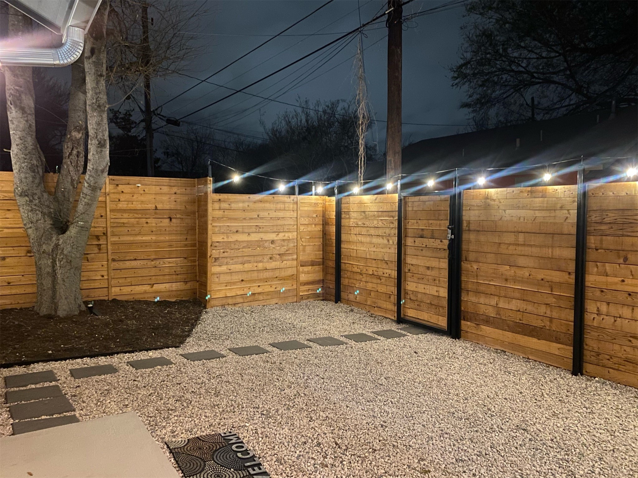 2102 East 2nd Street, Unit 2 Austin, TX 78702 - Photo 17 of 18 The home is fully gated with secure metal framing and key code locks, plus outdoor lighting on programmable timers.