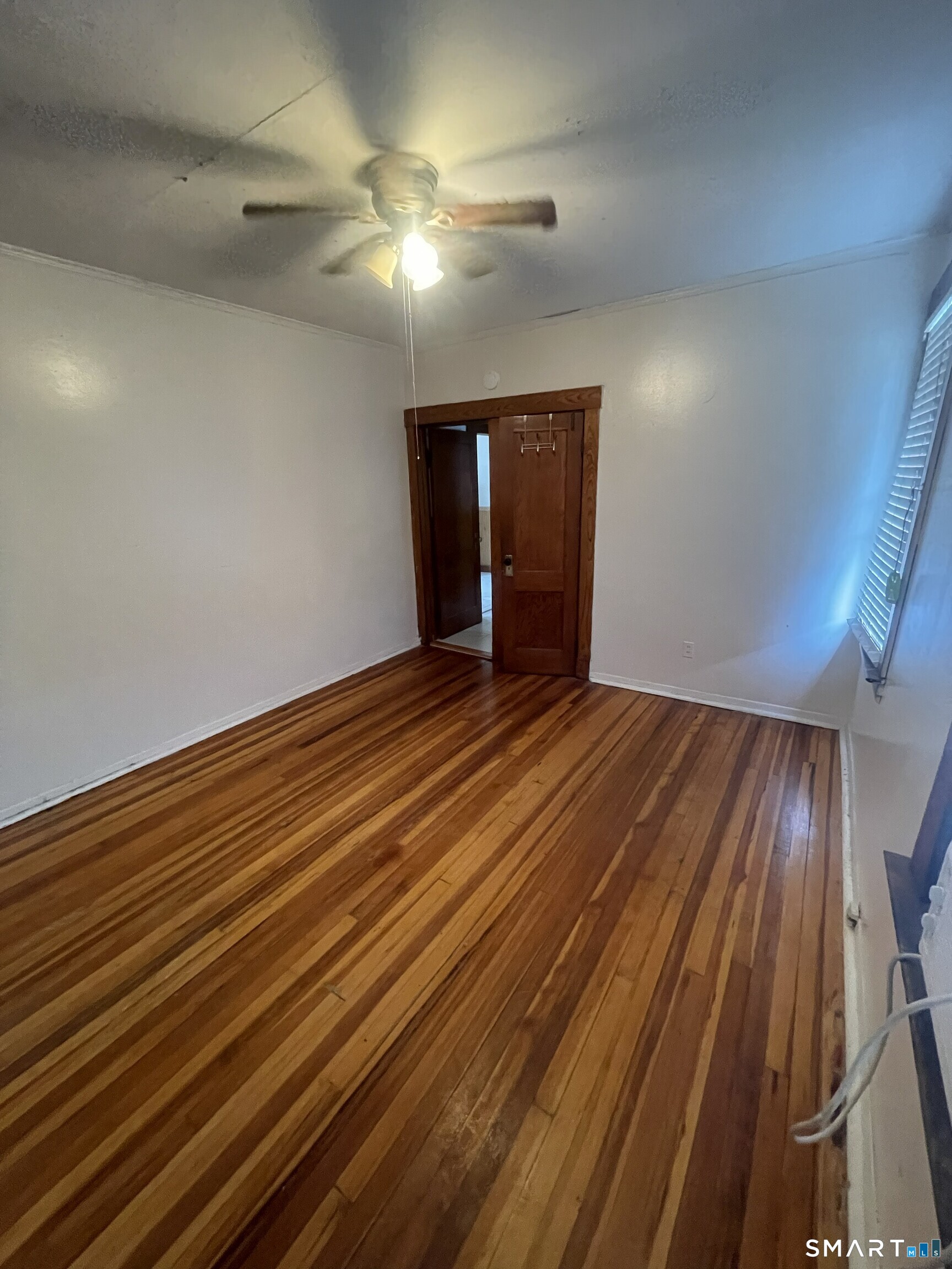 65 1st Street, Unit 2 Hamden, CT 06514 - Photo 11 of 15 wooden floor in an empty room with a chandelier
