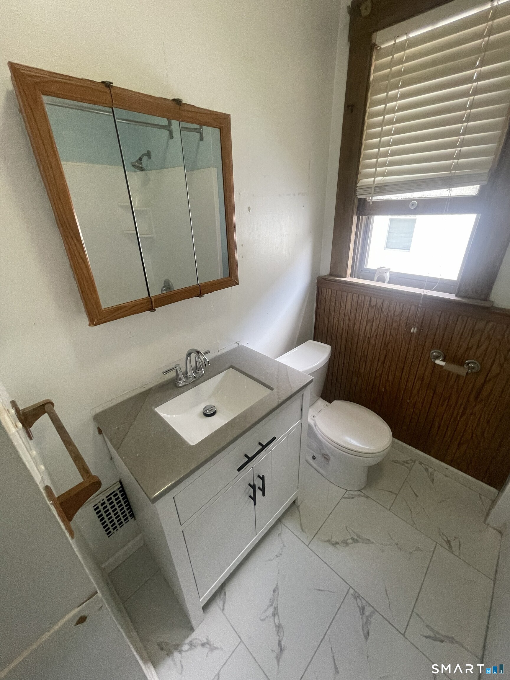 65 1st Street, Unit 2 Hamden, CT 06514 - Photo 14 of 15 a bathroom with a toilet sink and mirror