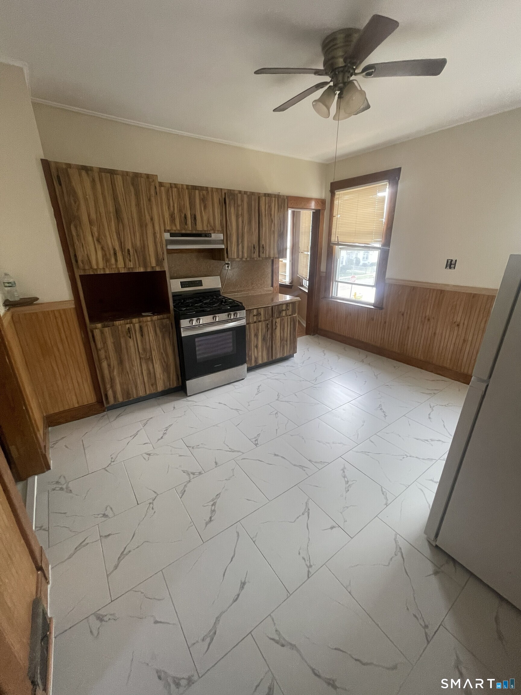 65 1st Street, Unit 2 Hamden, CT 06514 - Photo 7 of 15 a kitchen with granite countertop a sink a stove and cabinets