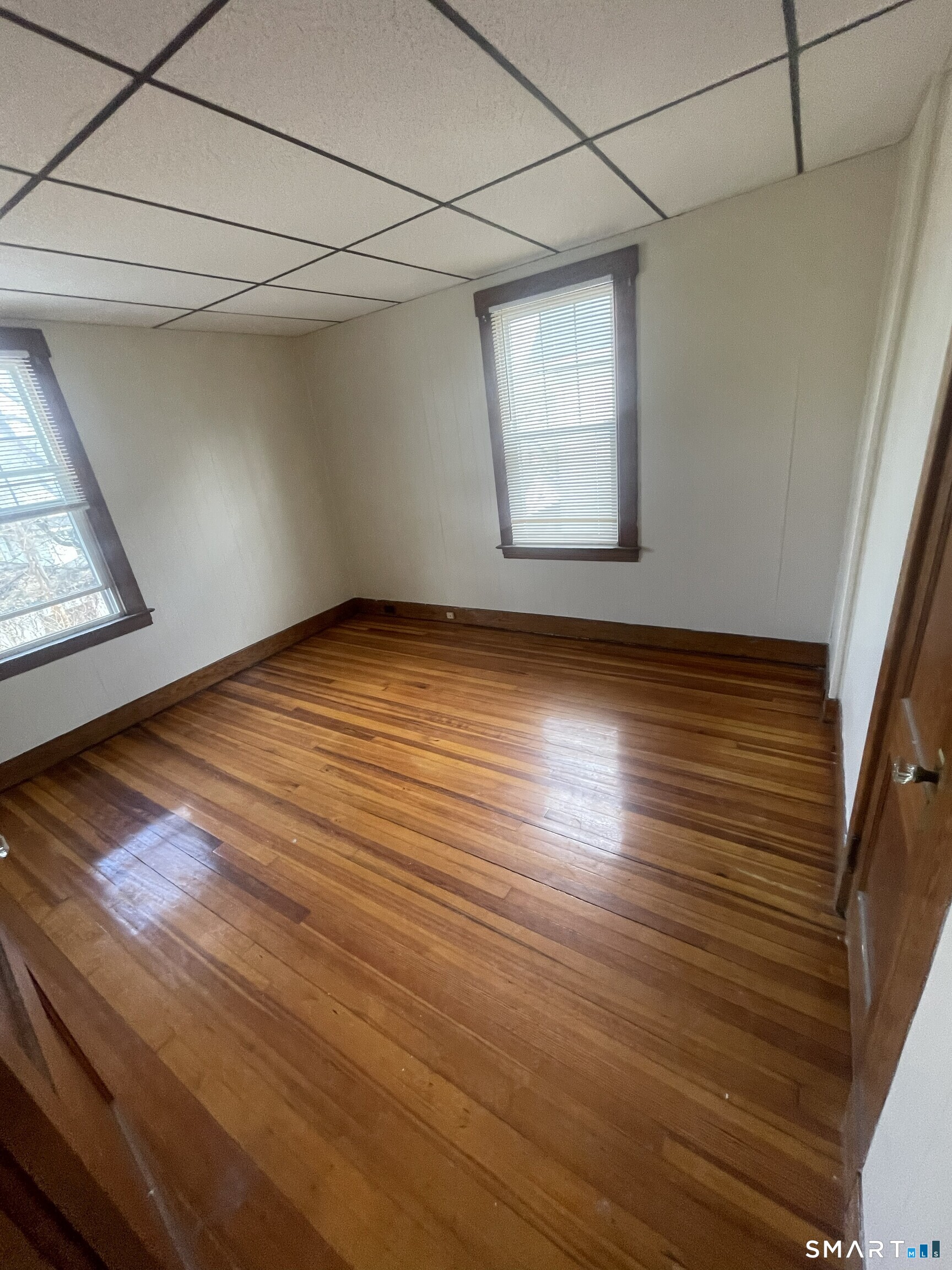65 1st Street, Unit 2 Hamden, CT 06514 - Photo 8 of 15 a view of an empty room with wooden floor and a window