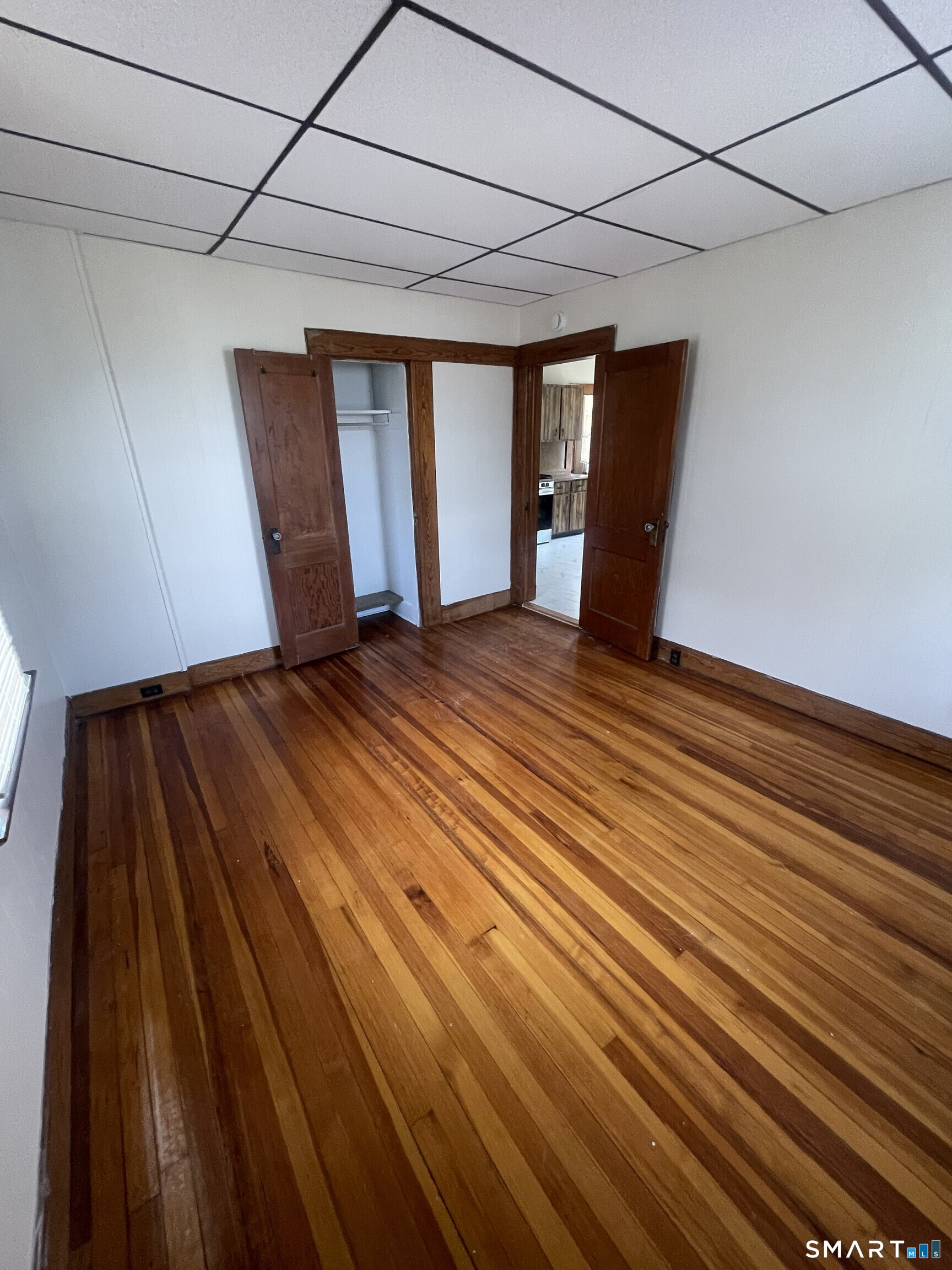 65 1st Street, Unit 2 Hamden, CT 06514 - Photo 9 of 15 a view of an empty room with wooden floor and cabinets