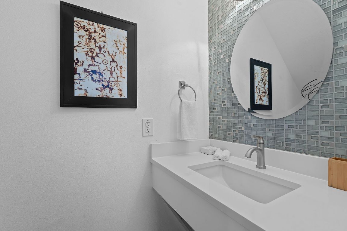 3603 East 12th Street Austin, TX 78721 - Photo 14 of 27 a bathroom with a sink and a mirror