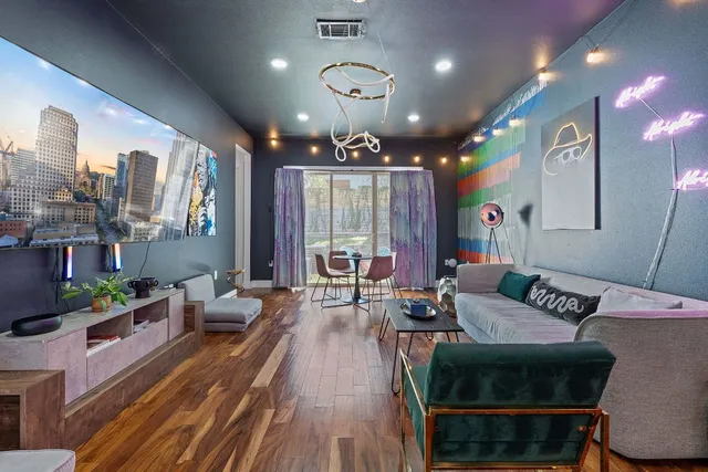 a living room with furniture a large window and a chandelier