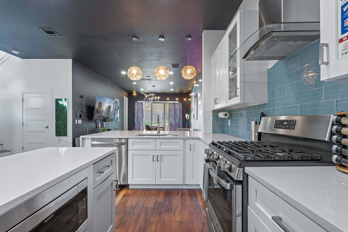 3603 East 12th Street Austin, TX 78721 - Photo 20 of 27 a kitchen with a sink stove and cabinets