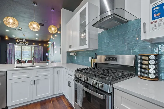 a white stove top oven sitting inside of a kitchen