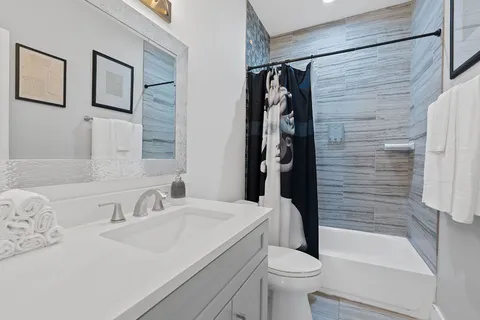 a bathroom with a sink toilet and shower