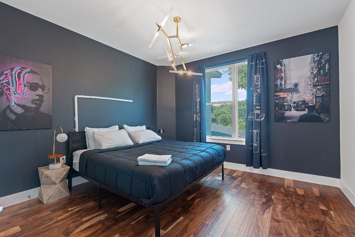 3603 East 12th Street Austin, TX 78721 - Photo 6 of 27 a bedroom with a large bed and a window