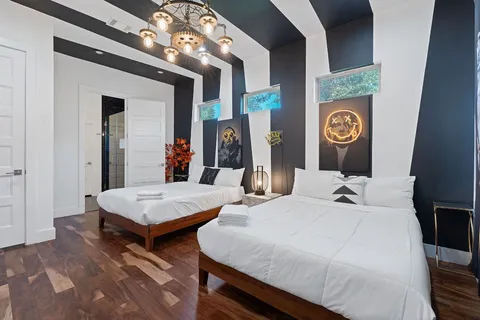 a bedroom with two beds and a table