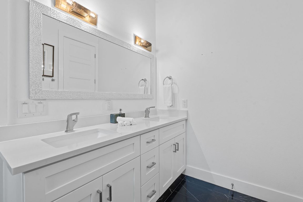 3603 East 12th Street Austin, TX 78721 - Photo 10 of 27 a bathroom with a sink and a mirror