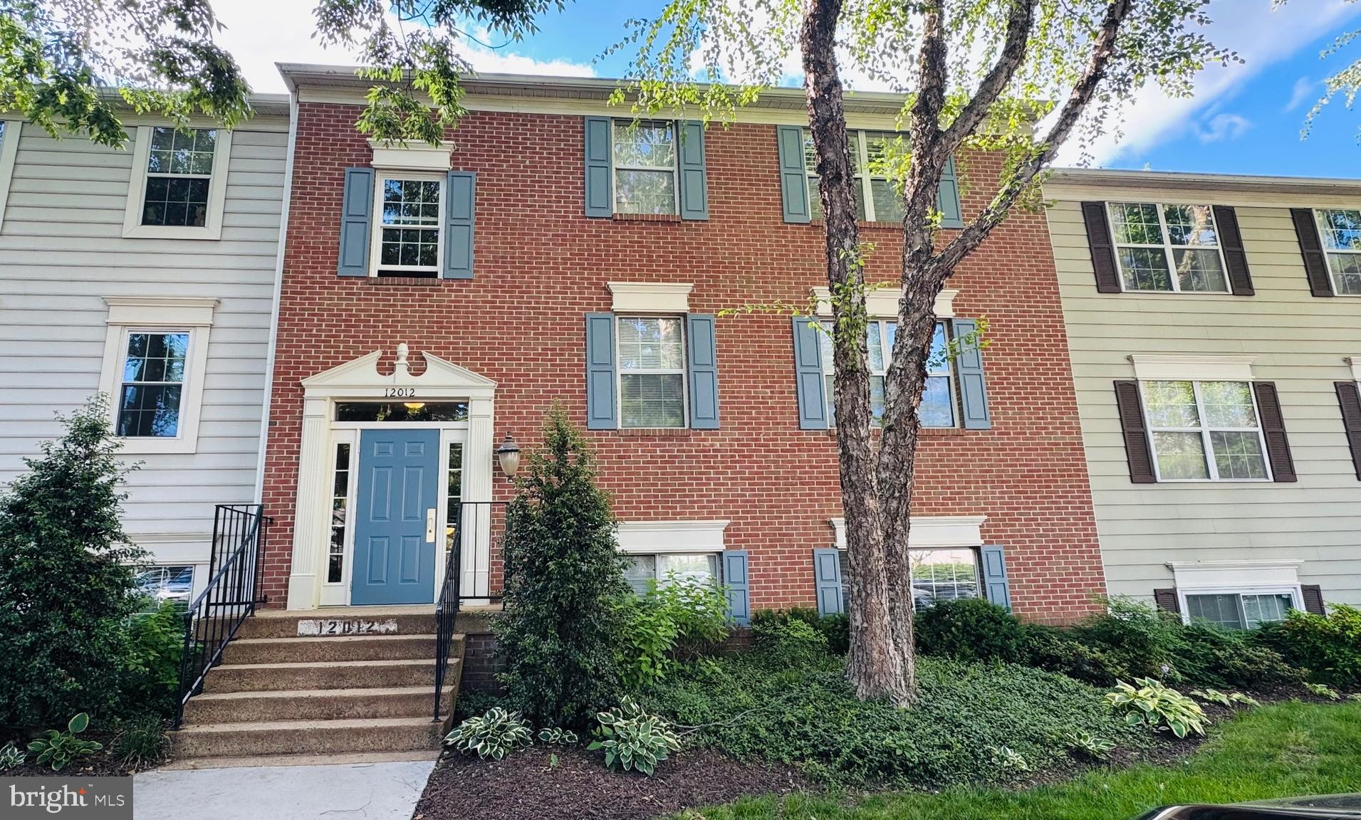 12012 Golf Ridge Court, Unit 374 Fairfax, VA 22033 - Photo 1 of 38 a front view of a house with yard and trees around