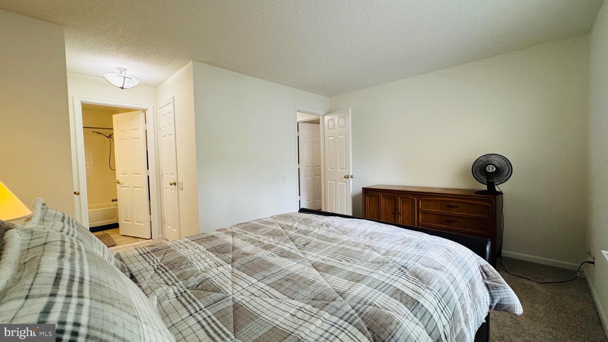 12012 Golf Ridge Court, Unit 374 Fairfax, VA 22033 - Photo 12 of 38 a bedroom with a bed and cabinets