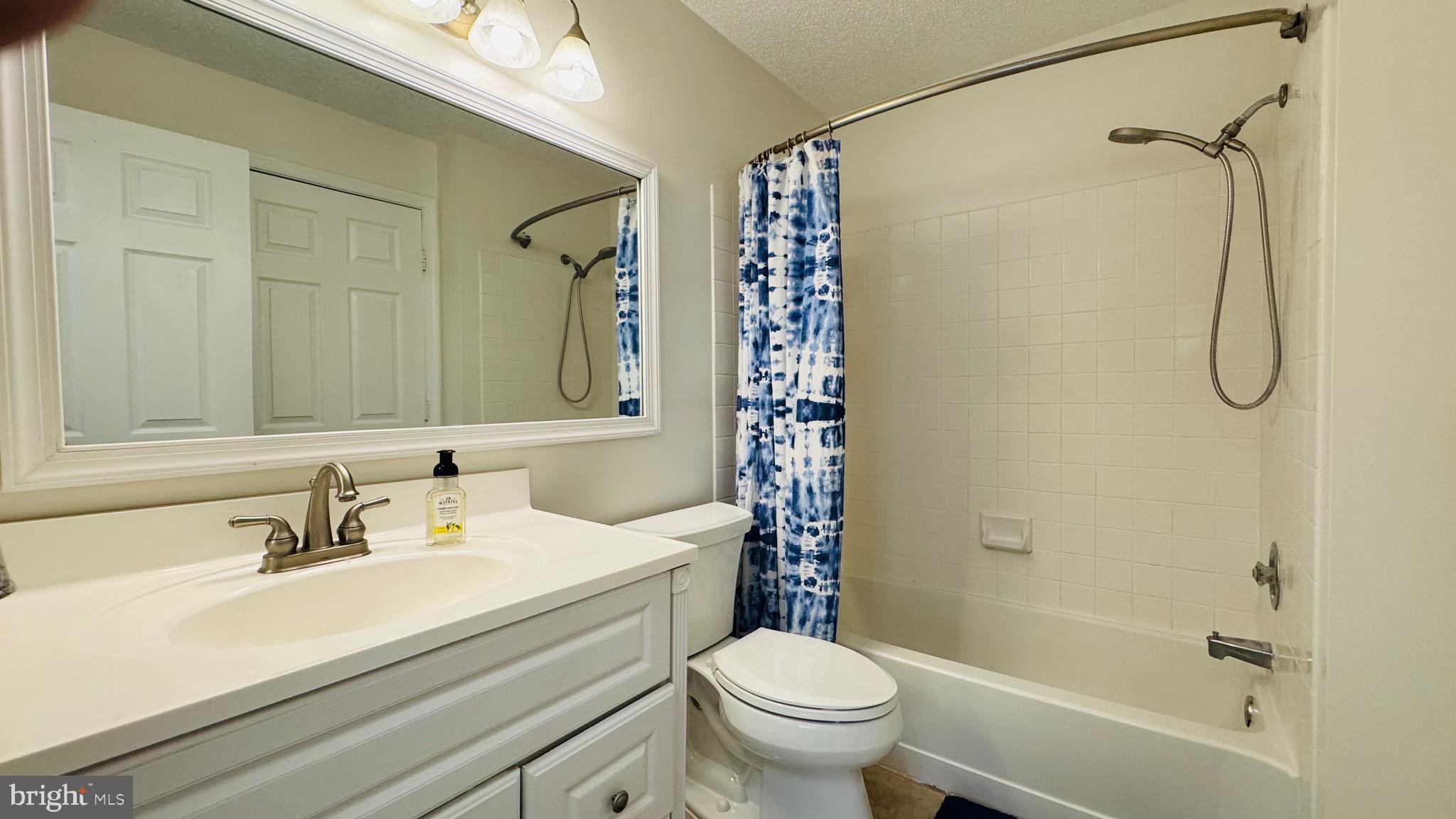 12012 Golf Ridge Court, Unit 374 Fairfax, VA 22033 - Photo 13 of 38 a bathroom with a sink a toilet and shower