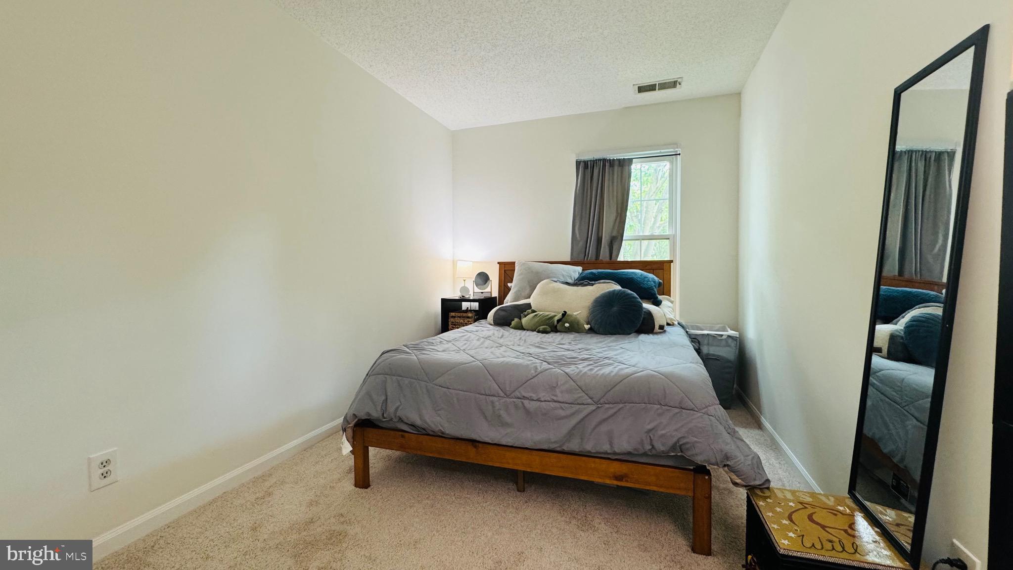 12012 Golf Ridge Court, Unit 374 Fairfax, VA 22033 - Photo 14 of 38 a bedroom with a bed and wooden floor