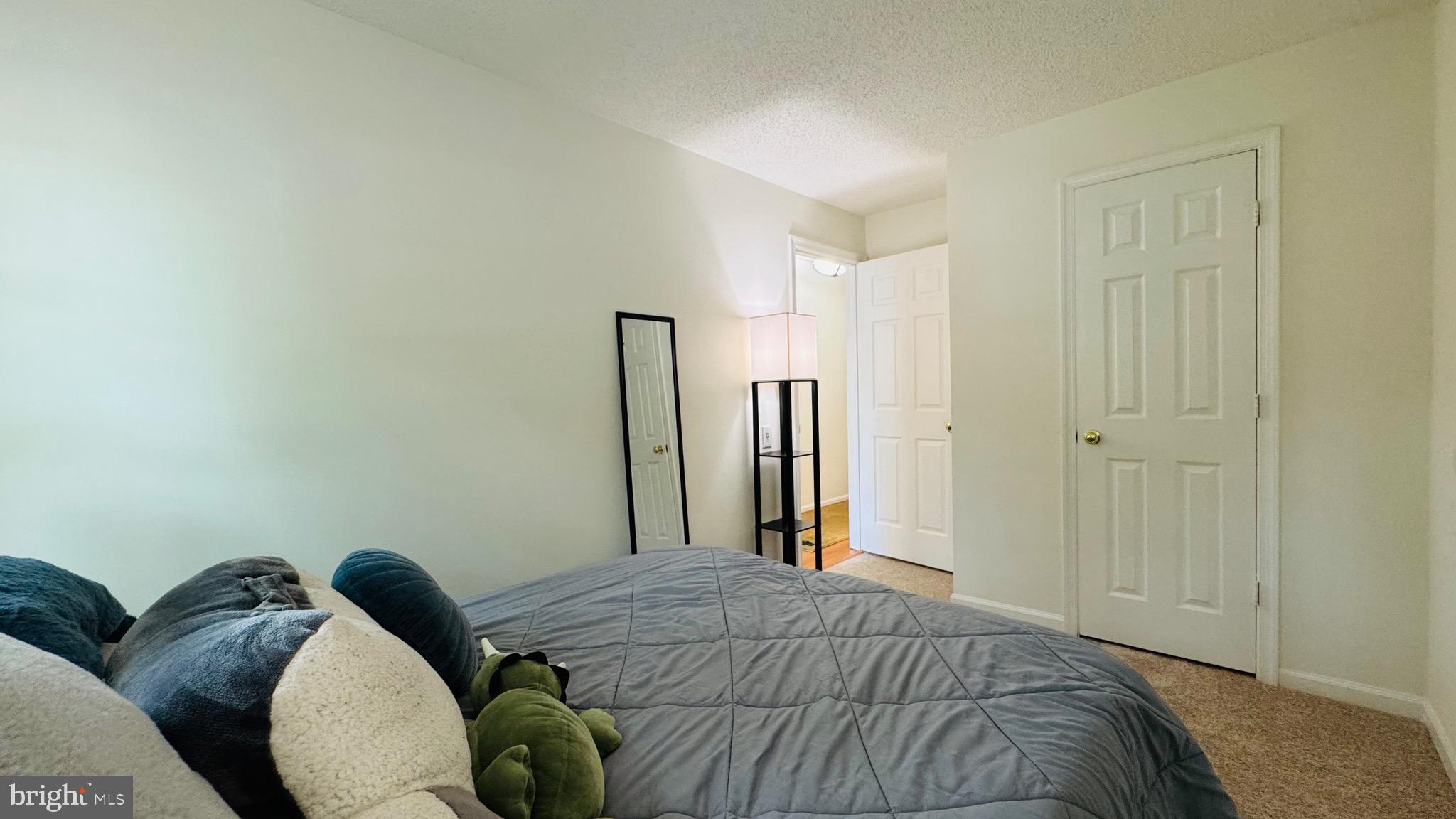 12012 Golf Ridge Court, Unit 374 Fairfax, VA 22033 - Photo 15 of 38 a bedroom with a bed and a closet