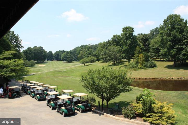 12012 Golf Ridge Court, Unit 374 Fairfax, VA 22033 - Photo 34 of 38 a view of a lake with lawn chairs