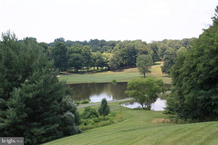 12012 Golf Ridge Court, Unit 374 Fairfax, VA 22033 - Photo 37 of 38 an aerial view of a house with a yard and lake view