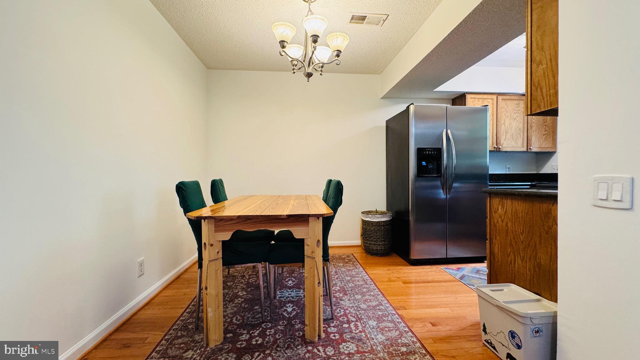 12012 Golf Ridge Court, Unit 374 Fairfax, VA 22033 - Photo 5 of 38 a dining room with furniture and a chandelier