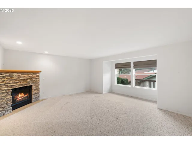 a view of an empty room with a fireplace