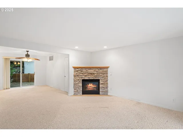 a view of empty room with a fireplace