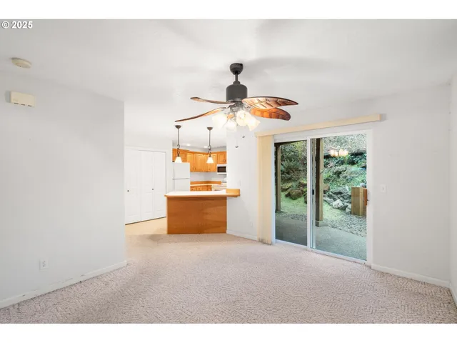 a view of a room with wooden floor and window