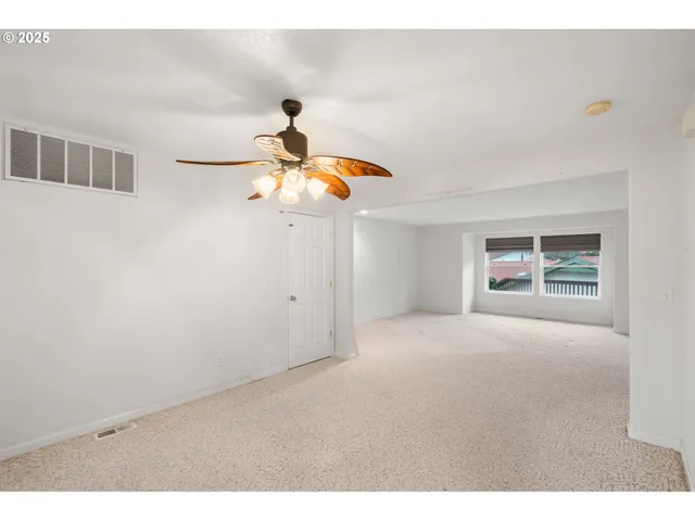 a picture of a room with a ceiling fan