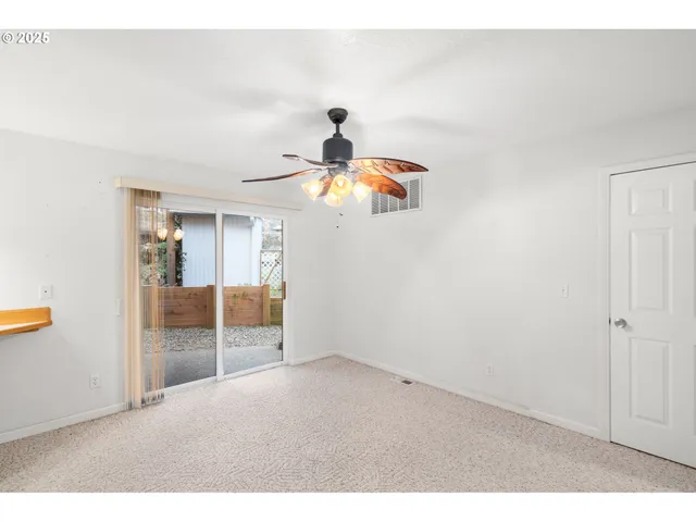 a view of a kitchen with kitchen island a sink a refrigerator and window