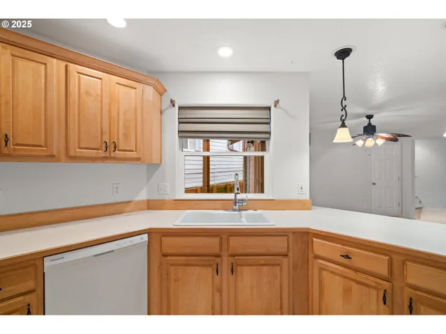 a kitchen with stainless steel appliances white cabinets and wooden floors