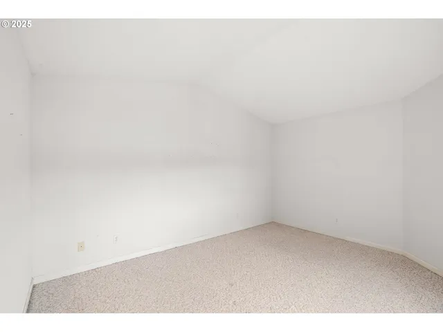 a view of an empty room and a window