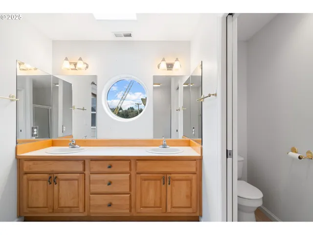 a view of a balcony with wooden floor and fence