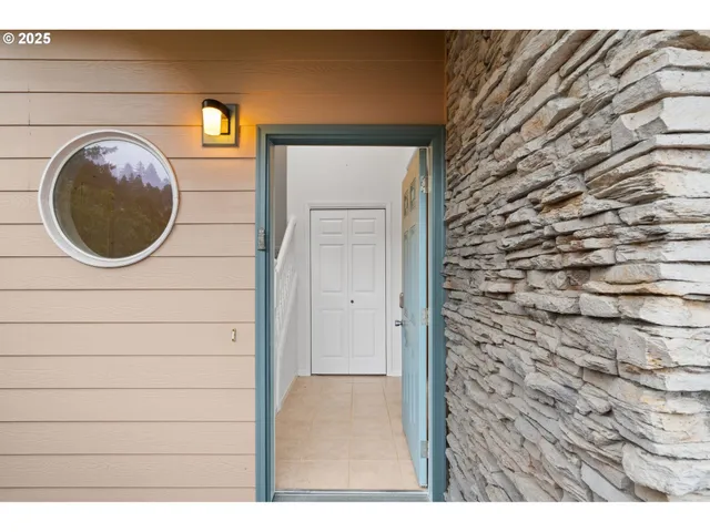 a view of a hallway with wooden floor and entryway